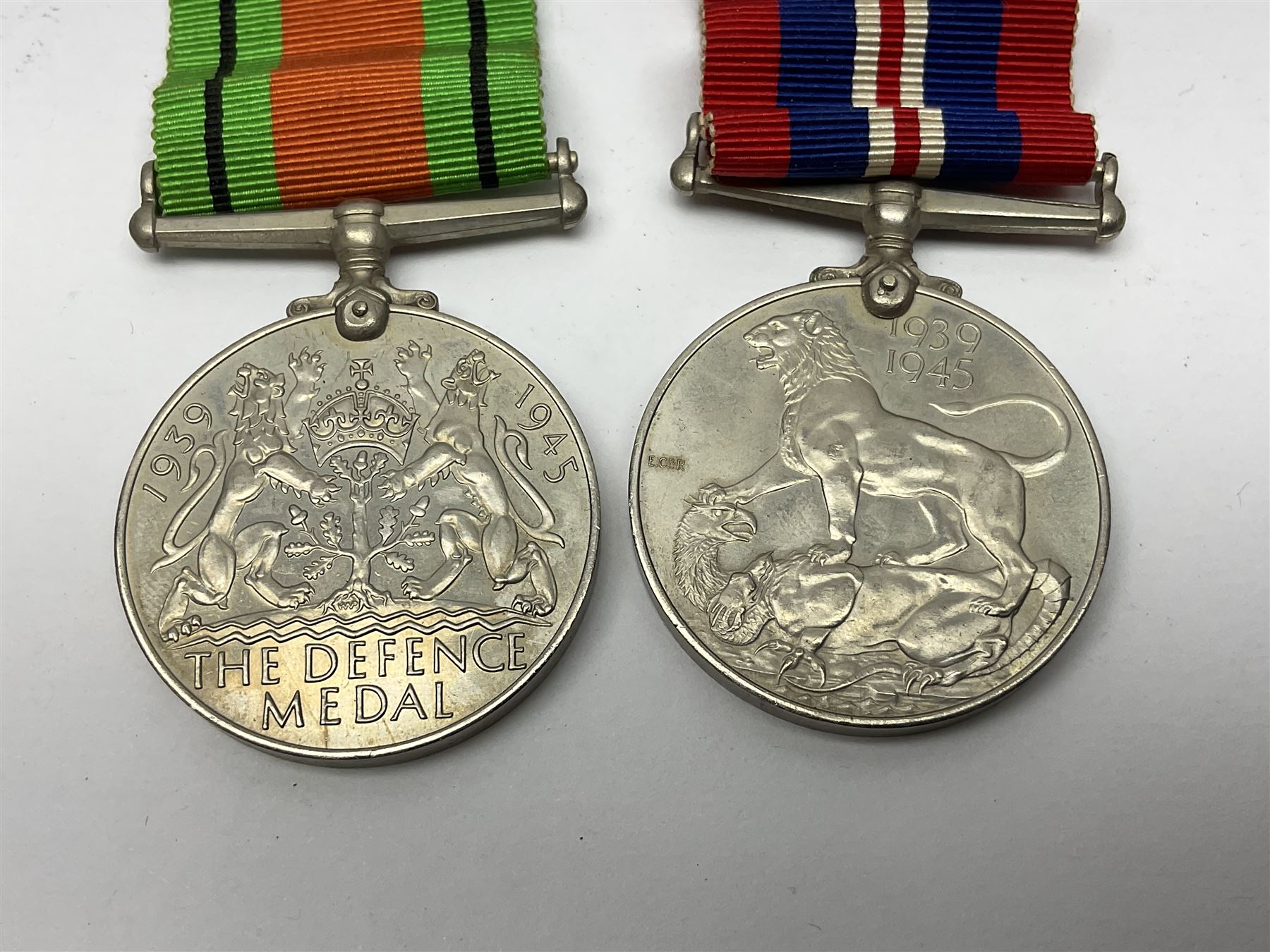 WW1 pair of medals awarded to 151761 Gnr. S. Loten R.A. with ribbons; four WW2 medals with ribbons; and small quantity of cap badges, medallions etc