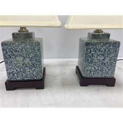 Pair of lamps of square form, decorated with scrolling stylised flower raised upon a footed base, including shades H42cm