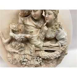 Pair oval continental plaques, decorated in relief with two figures, H20cm 