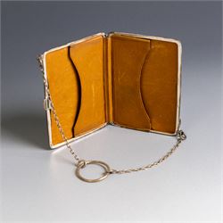 Early 20th century silver coin purse, with floral decoration and finger chain, hallmarked together with an early 20th century cigarette case,  with engraved initials, hallmarked and a silver filigree cigarette case