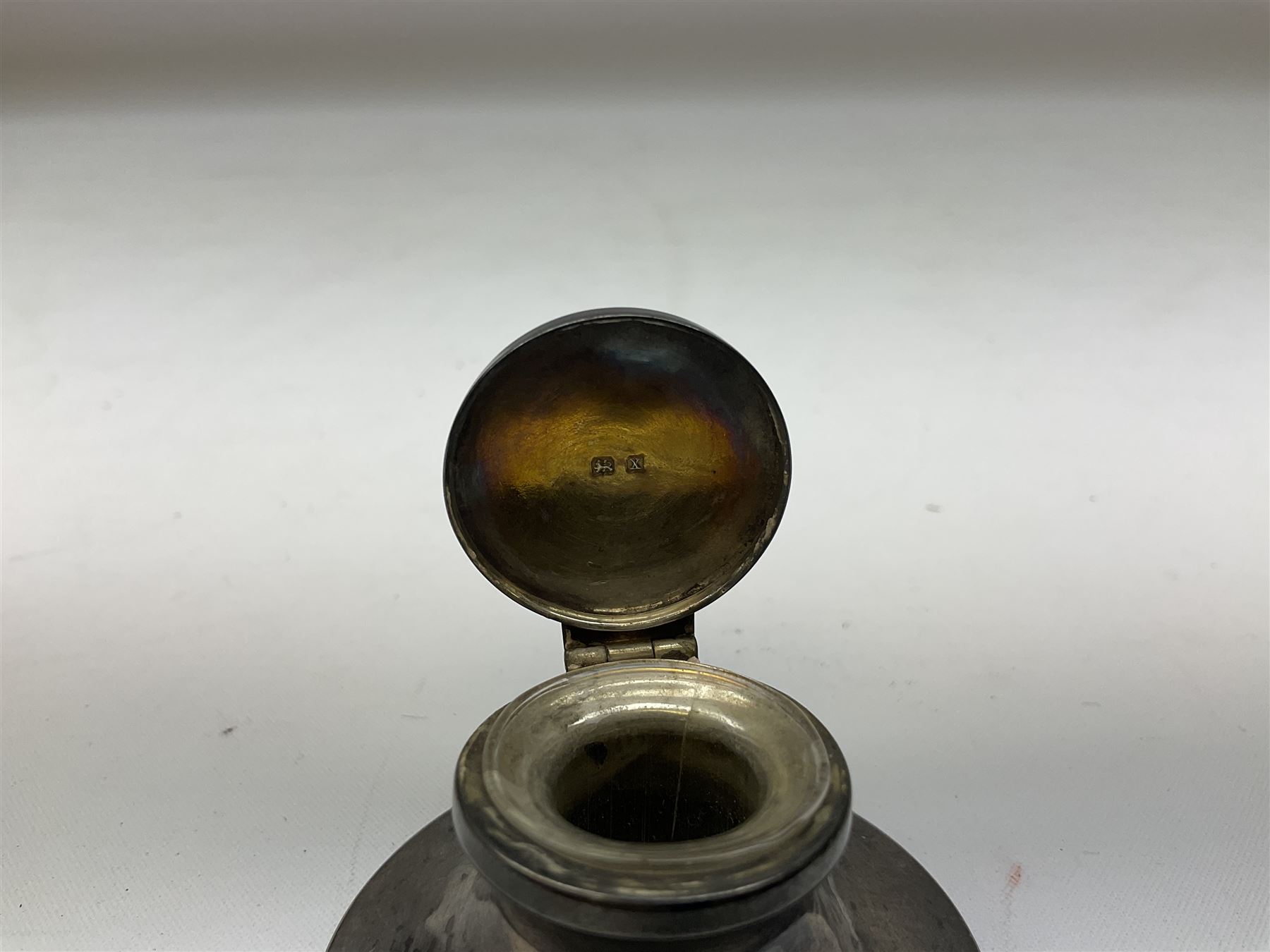 German silver pill box of oval form, the cover decorated with a serpent, stamped with crown and crescent and marked 800, together with a miniature silver capstan inkwell with glass liner, hallmarked Birmingham, a novelty silver teaspoon with golf club terminal, hallmarked Birmingham, and an amber glass scent bottle with silver plated cover, approximate weighable silver (not including inkwell or scent bottle with silver plated cover) 41.9 grams