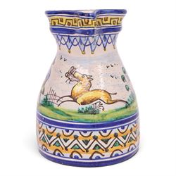 19th century Spanish faience jug with polychrome tin glaze decorated depicting a hunter and dog in a country scene within a geometric boarder, H18cm