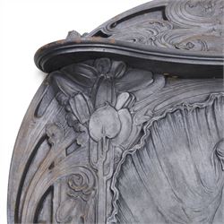 Art Nouveau cast iron fireplace, shaped hood with scrolling foliate crest, relief cast panel of female figure seated within shell form amidst wave motifs, uprights cast with foliate designs