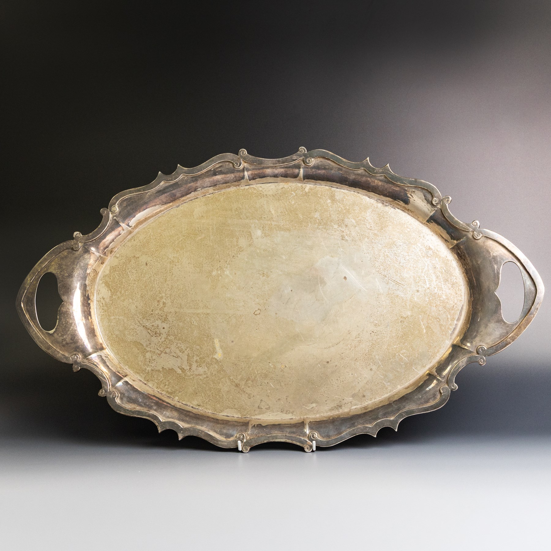 Edwardian silver twin handled tray, of navette form with C scroll decoration to the outer rim, hallmarked Goldsmiths & Silversmiths Ltd, London 1907, handle W61cm