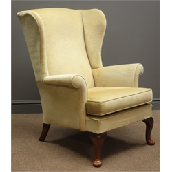  Parker Knoll beech framed wingback armchair, upholstered in beige fabric  