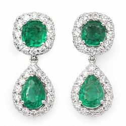 Pair of 18ct white gold emerald and diamond pendant earrings, each stud set with a cushion...