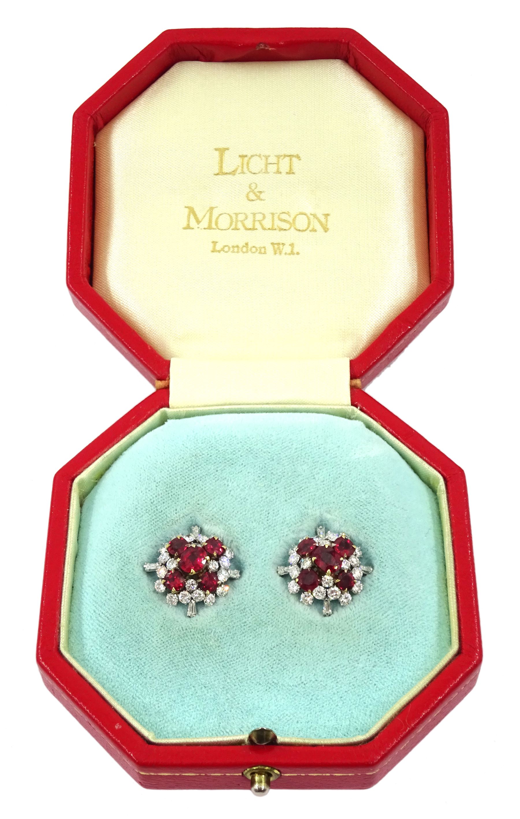 Pair of 18ct white and yellow gold Burmese ruby and diamond stud earrings, each cluster with five oval and round cut rubies and round brilliant cut and tapered baguette cut diamonds, total ruby weight approx 3.40 carat, total diamond weight approx 2.25 carat, in fitted box by Licht & Morrison, London