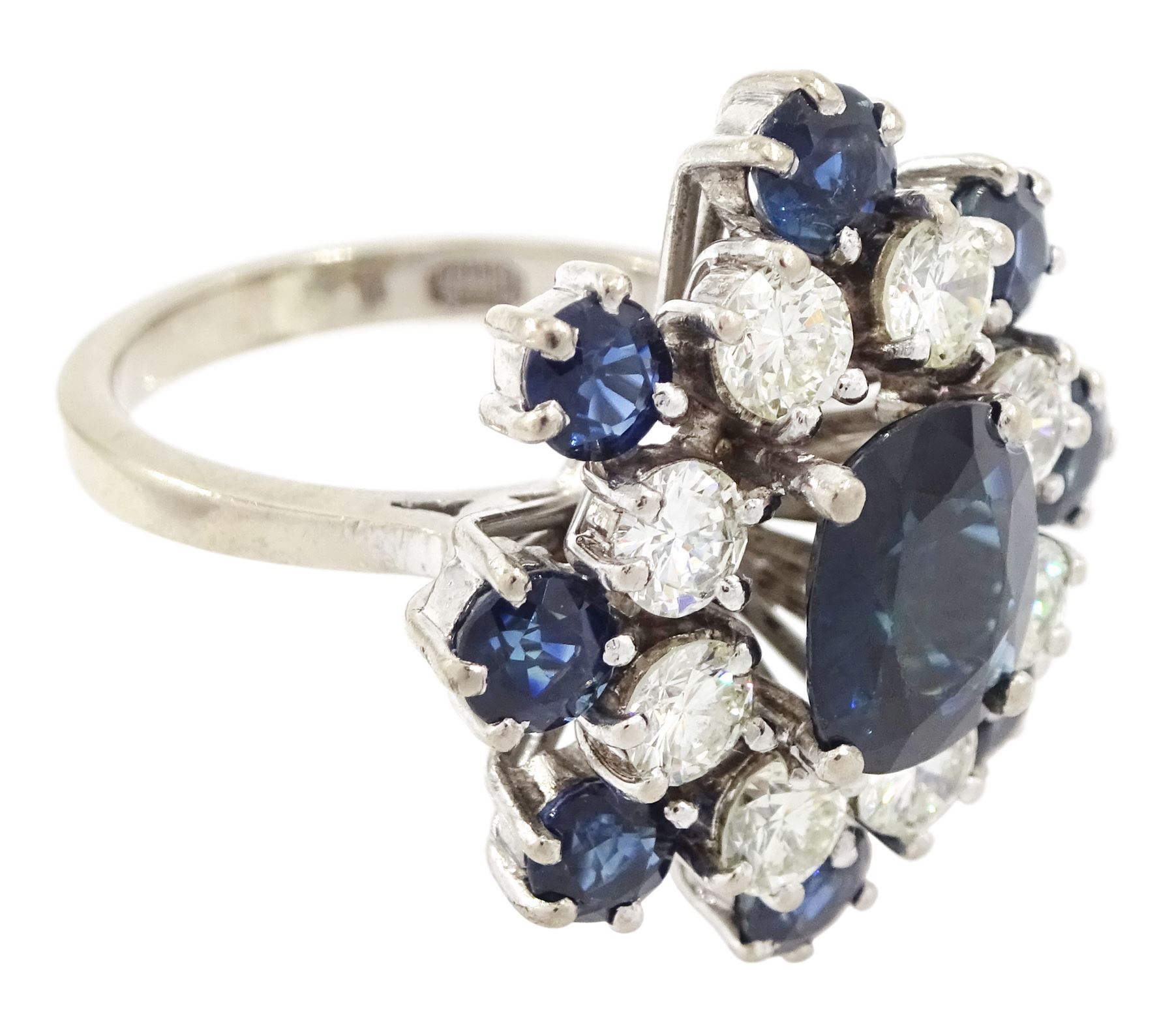 18ct white gold sapphire and diamond cluster ring, single oval cut sapphire of approx 1.85 carat, surrounded by eight round brilliant cut diamonds and eight round cut sapphires, stamped Graff, total sapphire weight approx 3.40 carat, total diamond weight approx 1.35 carat