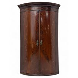 Late Georgian mahogany hanging corner cupboard, moulded cornice with interlaced boxwood st...