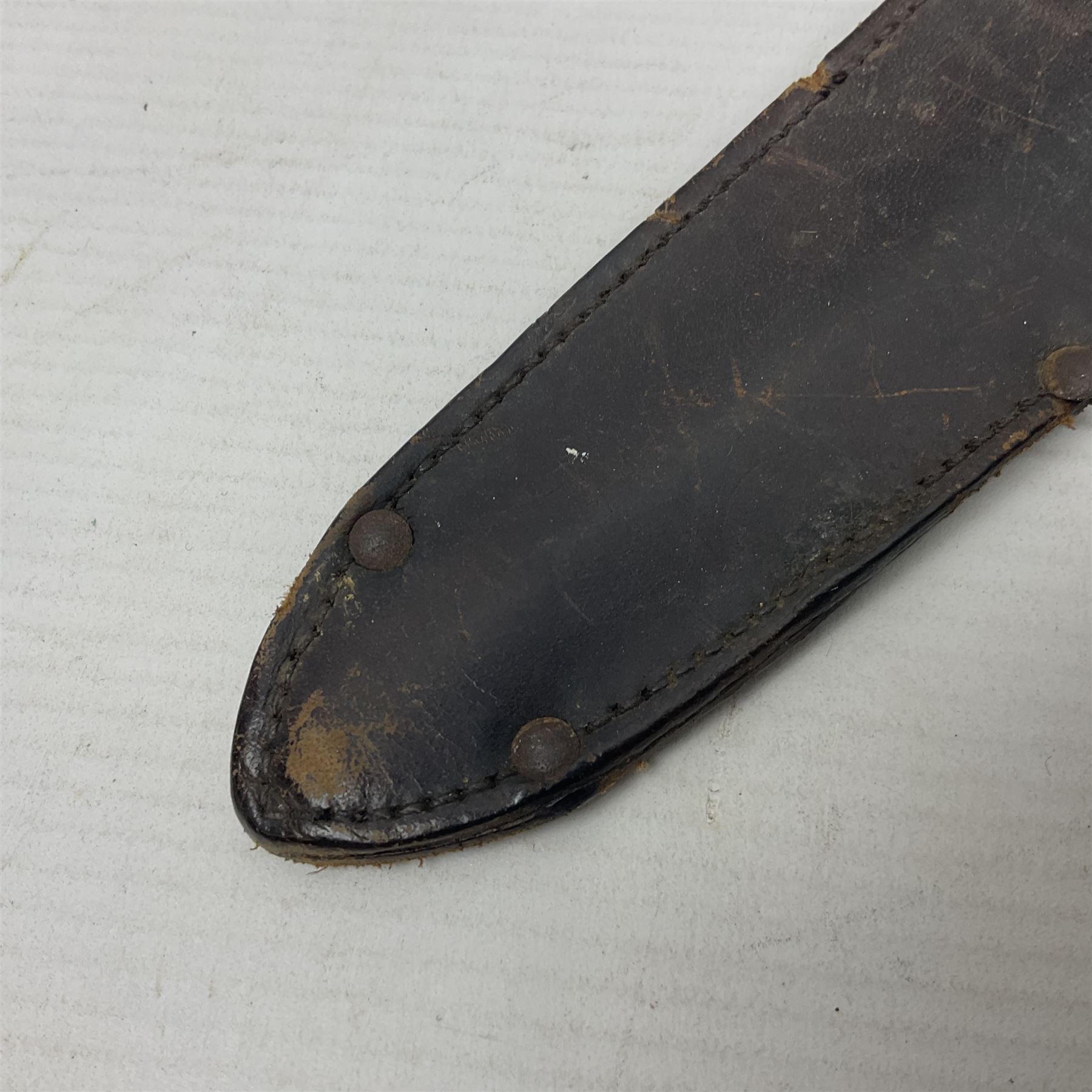  British Private Purchase fighting knife by William Rodgers, Sheffield, the 15cm double edge steel blade with raised medial ridge, stamped on one side of the ricasso WILLIAM RODGERS I CUT MY WAY, the opposing side marked MADE IN SHEFFIELD, ENGLAND, with aluminium crossguard and pommel, stacked leather washers grip and leather scabbard L27.5cm overall; and a crudely made short sword with 32.5cm single edged blade and steel knucklebow hilt with hardwood grip; in cane bound wooden scabbard L45cm overall (2)