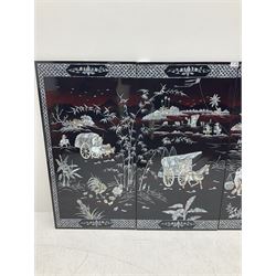 Four Chinese lacquered and mother of pearl inlaid wall panels, depicting horse and ox drawn carts, and figures at work within a landscape detailed with cockerels, bamboo and other trees, each panel H97.5cm W49.5cm