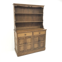  Medium oak dresser with two tier plate rack, two drawers above four cupboard doors, panelled sides, W121cm, H182cm, D48cm  