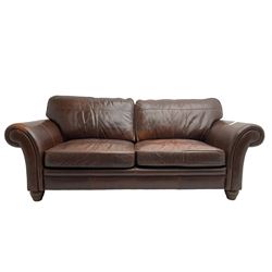 Traditional shaped large two seat sofa with scrolled arms, upholstered in chocolate brown leather with olive green back, raised on turned feet