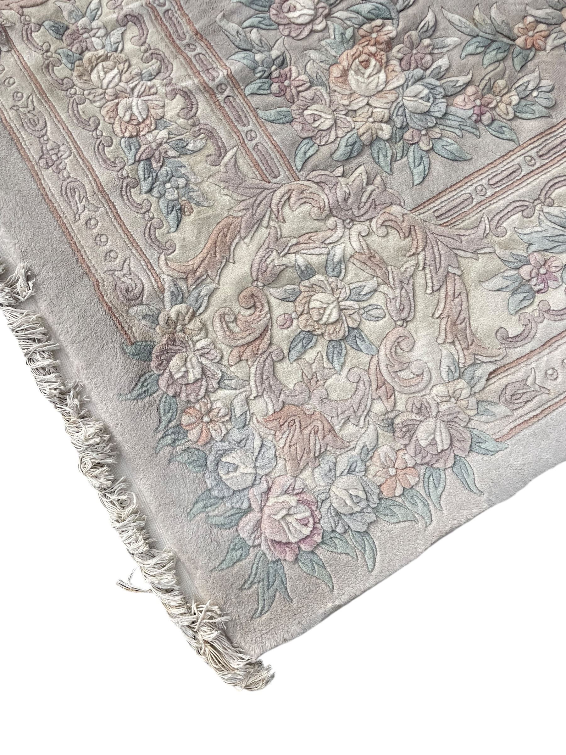 Chinese washed woollen pale ground carpet with overall floral design 