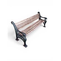 Neoclassical design cast iron and oak slatted garden bench, the twin end supports in the form of a Sphinx with acanthus carved knees and large paw feet, the pierced lattice bracket with Yorkshire rose motifs