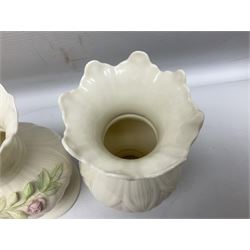 Five late 19th/early 20th century and later Belleek vases, comprising pair of Lotus Blossom examples, shamrock tree trunk vase, twin handled shamrock vase and a baluster form vase decorated with applied roses, all with printed marks beneath, tallest H16cm