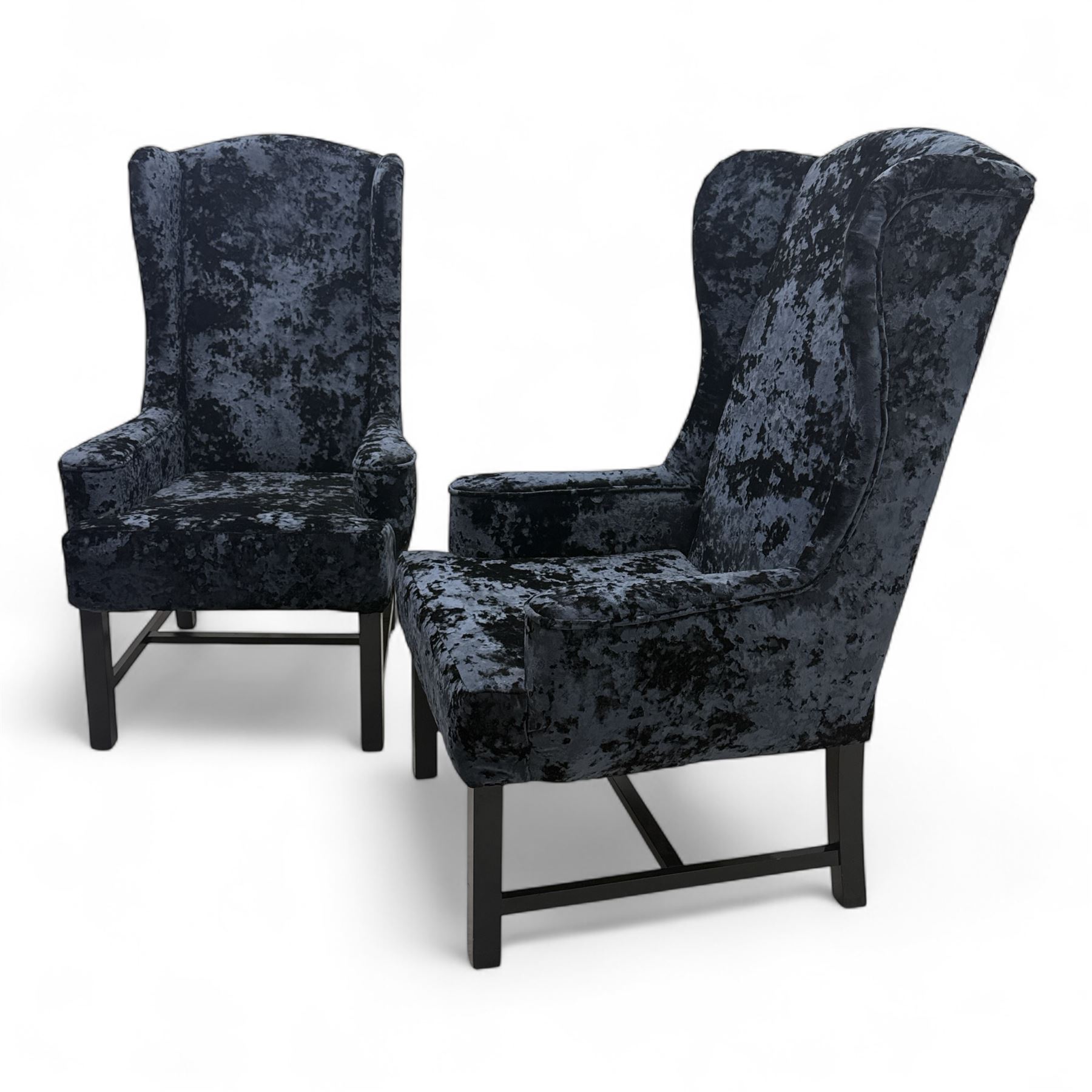 Oka - Pair of contemporary upholstered wingback armchairs, in black and blue textured velvet effect fabric, with tall scroll wing sides and square tapered legs joined by stretchers