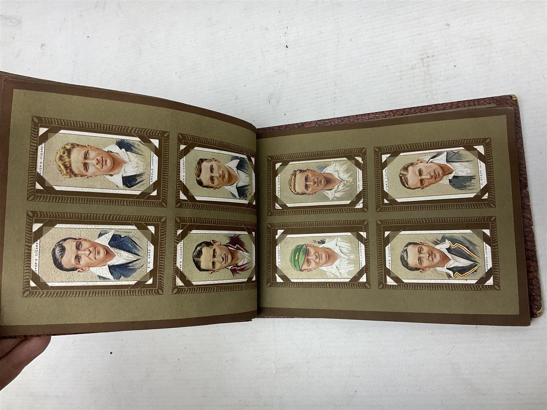 Three albums of cigarette cards including Wills Recruiting Posters, Military Motors and Allied Army Leaders, cricketers etc; another album containing a large quantity of laid-in cigarette cards; and an album of thirty-seven postcards of dogs by Mac (5)