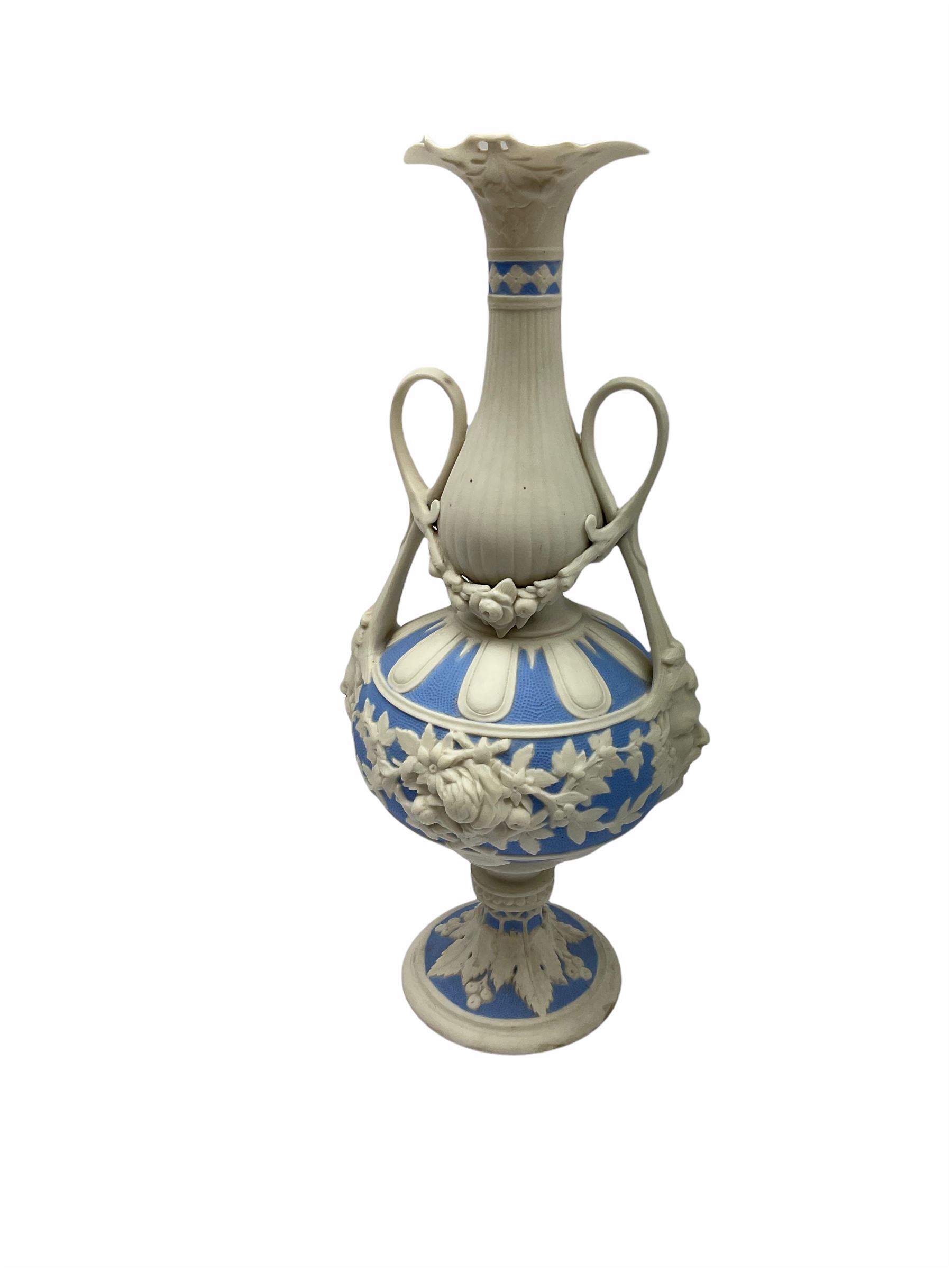 Victorian Parian ware twin handled vase detailed with Bacus masks fruiting vines and floral sprays H36cm, together with a Parian jug H14.5cm, classical Parian sculpture H40cm, decorative plaque decorated in high relief depicting two children D18.5cm. 