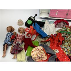 The World of Barbie Double Doll Case containing a quantity of assorted doll's clothing; together with two large and one small fashion dolls.