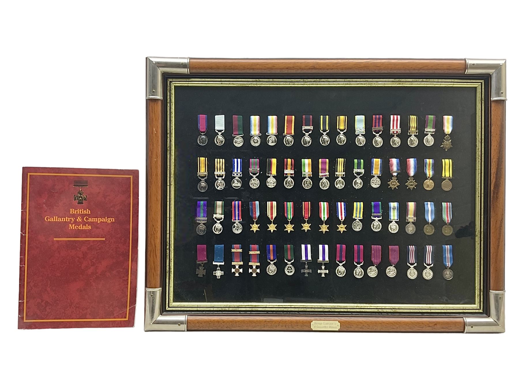 Limited edition large framed display board with sixty half-size copies of British Gallantry and Campaign Medals produced by Danbury Mint; all with ribbons and associated booklet