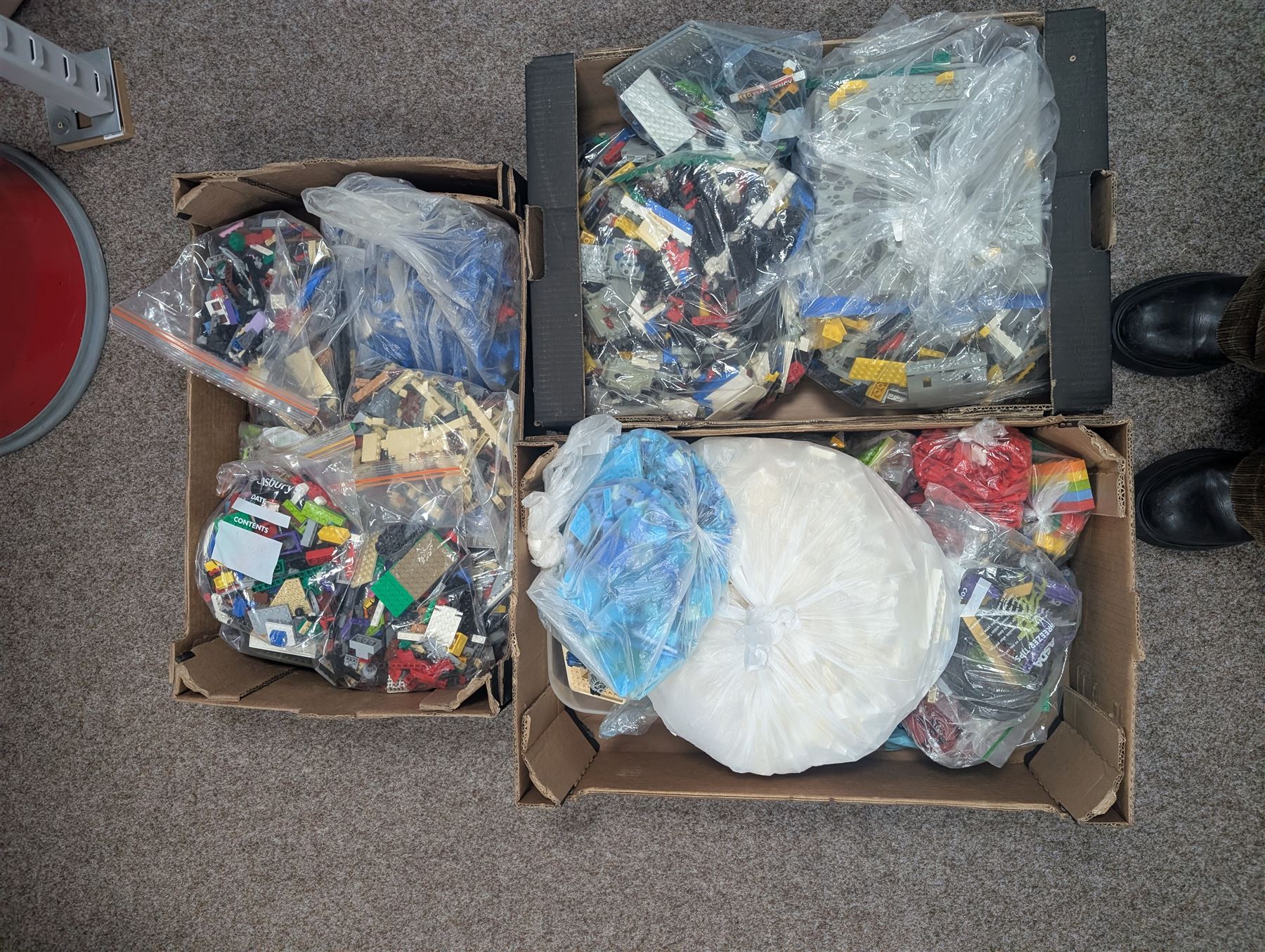 Large collection of loose Lego, including minifigures, together with three Lego ideas books, in five boxes