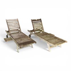 Pair of teak garden sun loungers, with slatted adjustable backrests, integrated wheels and...