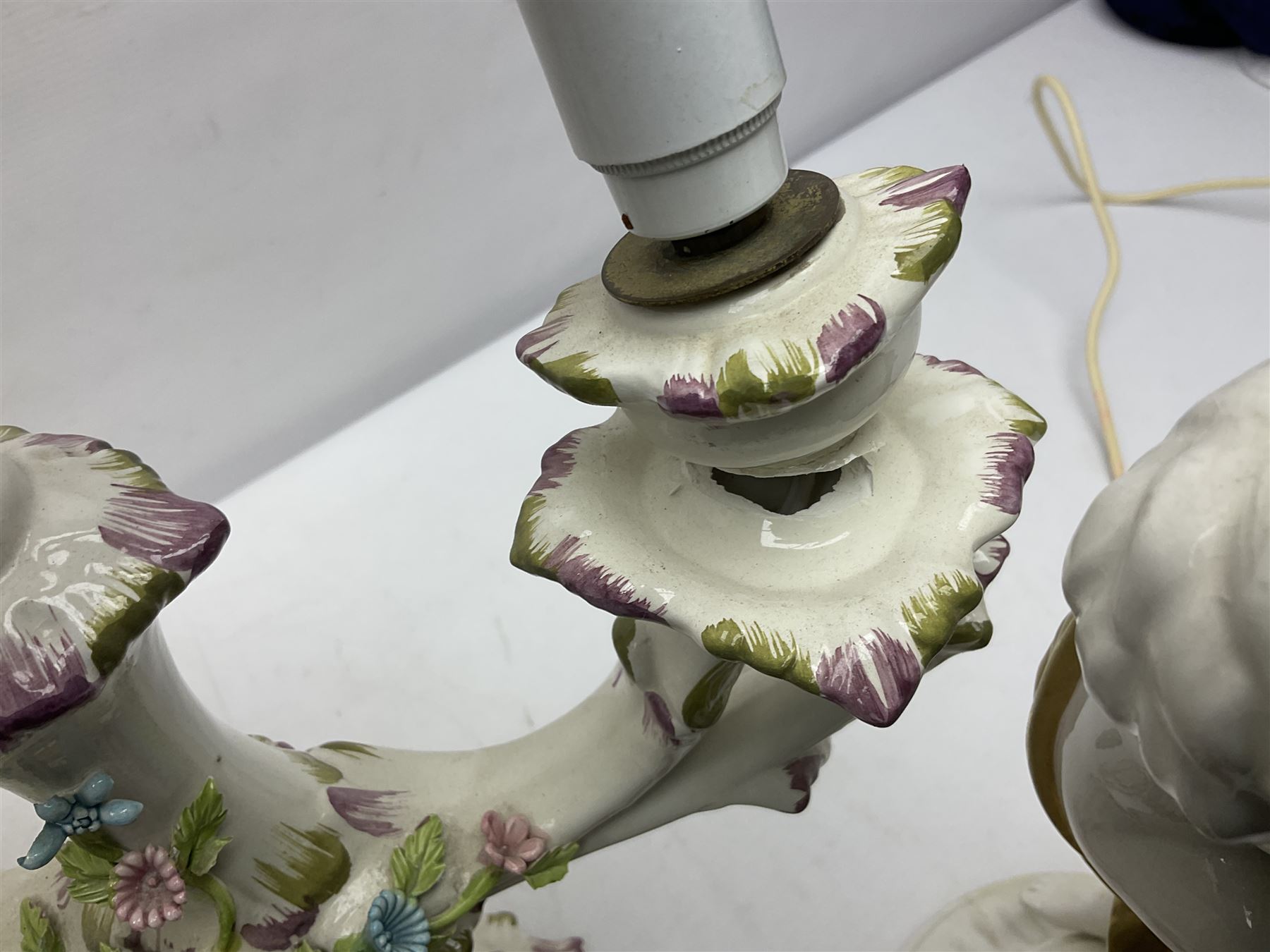 Jaffe Rose figural ceramic table lamp, modelled as two putti climbing a column with gilded cloth, together with a Capodimonte floral two light table lamp and a collection of lamp shades