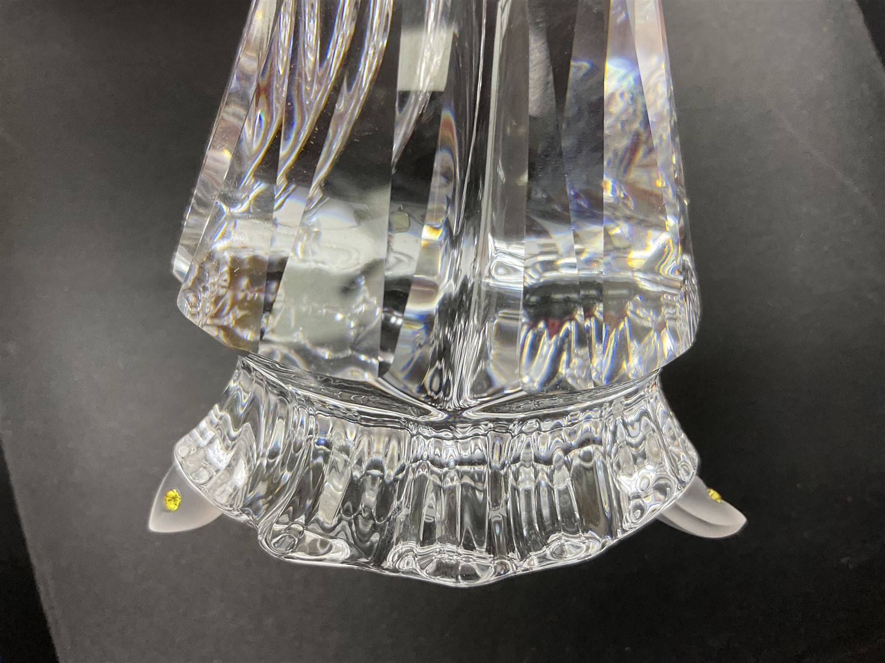 Swarovski Crystal Masquerade trilogy; 1999 Masquerade Pierrot, 2000 Columbine, 2001 Harlequin all with accompanying plaque, stand and original box, together with a glass display case with mirrored back and sides 