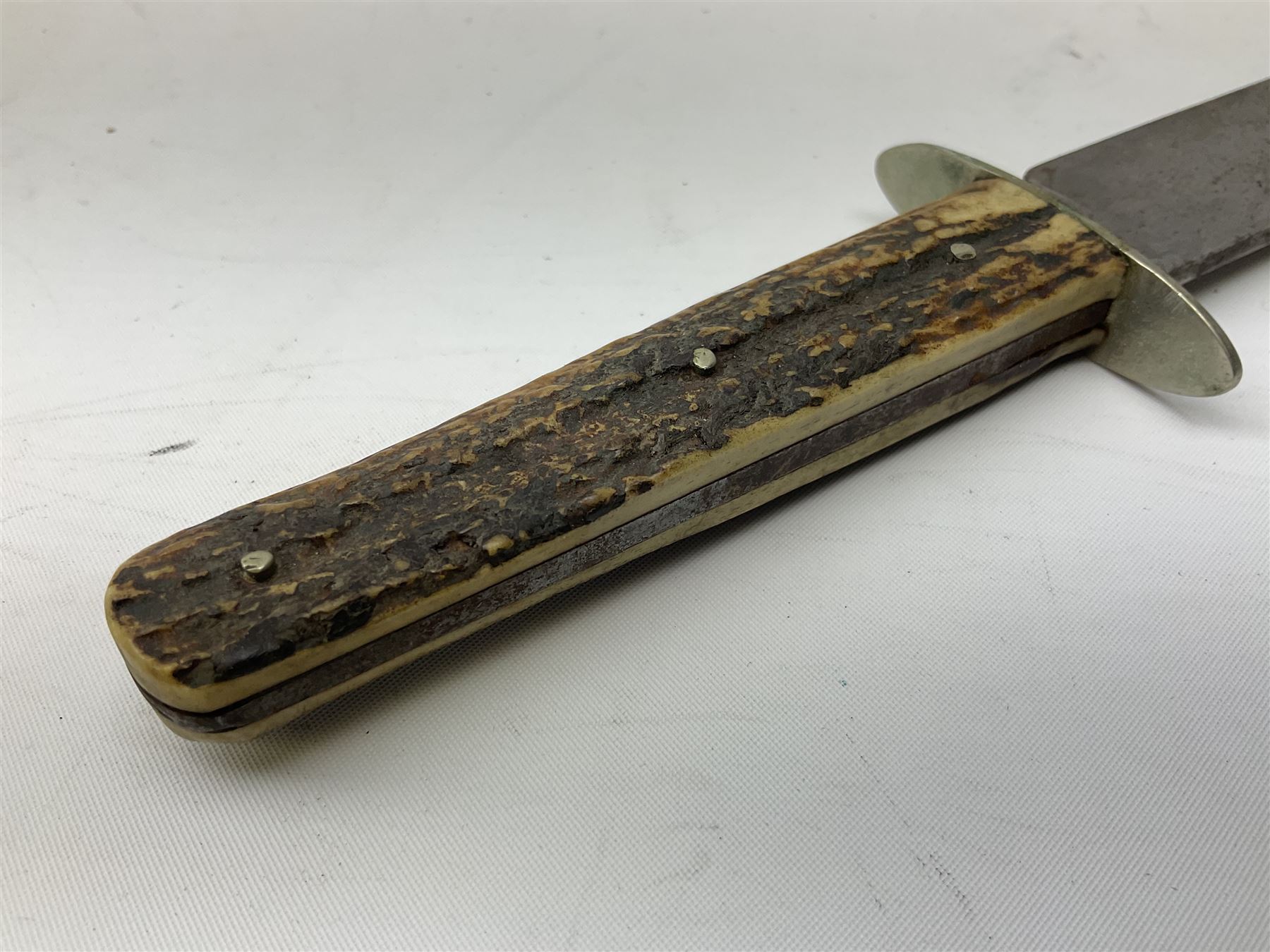 Hunting knife by J Nowill & Sons, Sheffield, the handle inset with mother of pearl, blade length 19cm; George Wolstenholme IXL lock-knife with antler scales L29cm open; and another Bowie style hunting knife marked 'V.R. Warranted Sheffield Joseph Ellis & Sons' in leather sheath (3)