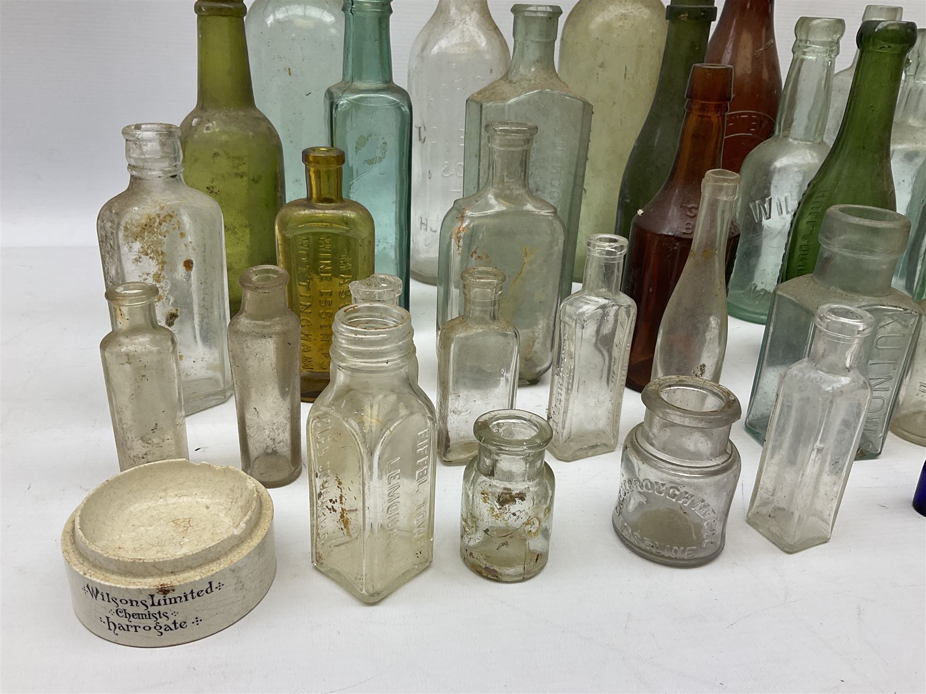 Collection of various vintage glass bottles and stoppers, including advertising bottles, sauce bottles and medical bottles etc