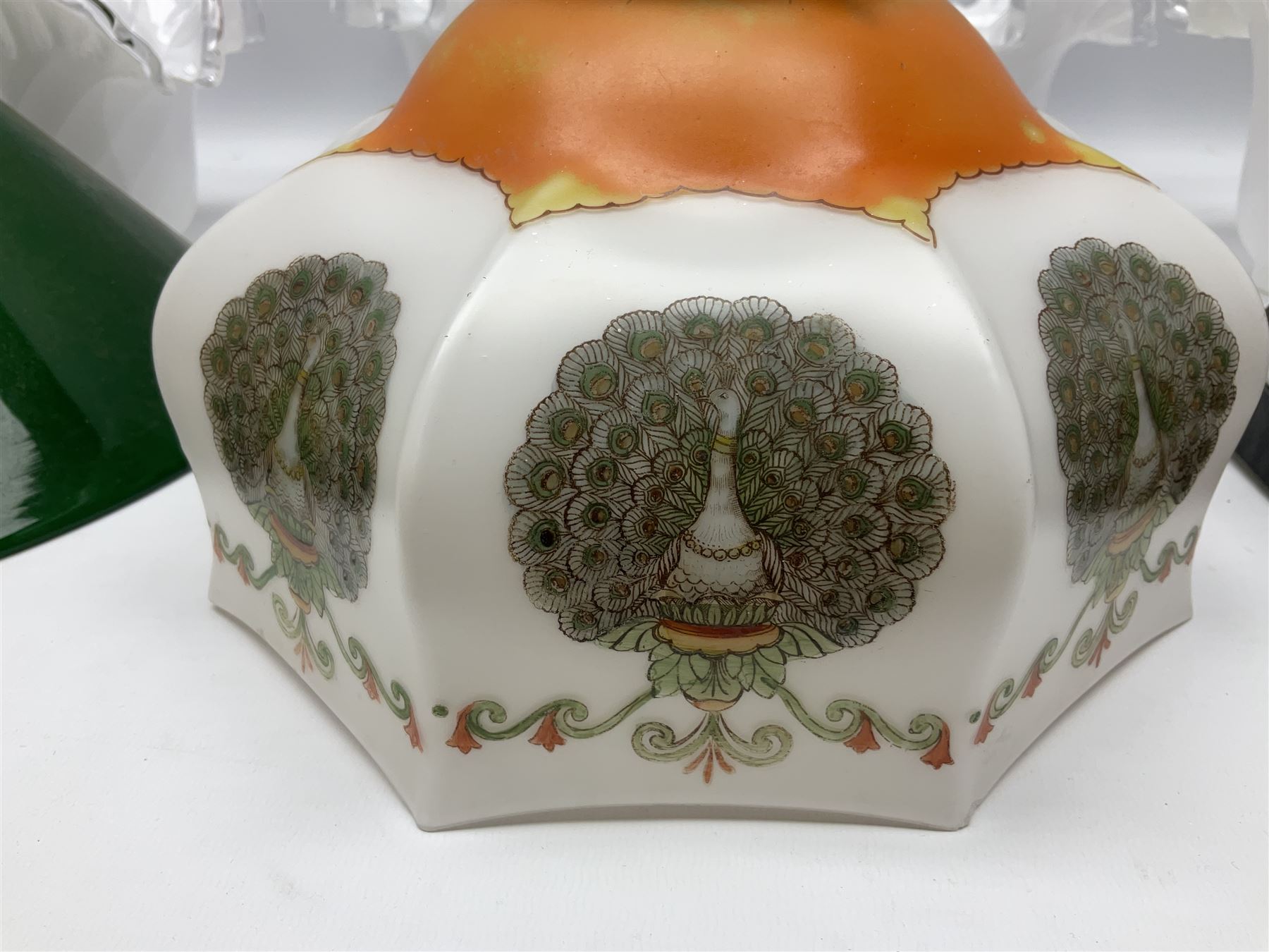 Milk glass lampshade decorated with peacocks, together with a Tiffany style lampshade, a set of five white frilled lamps shades etc 