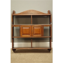  Edwardian walnut wall cupboard, arched cresting above six compartments and two panel doors, W74cm, H85cm, D18cm  