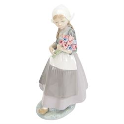 Three Lladro figures, comprising Spring Awakening 1283, Flower Harmony 1418 and Dutch girl with Tulips 5065