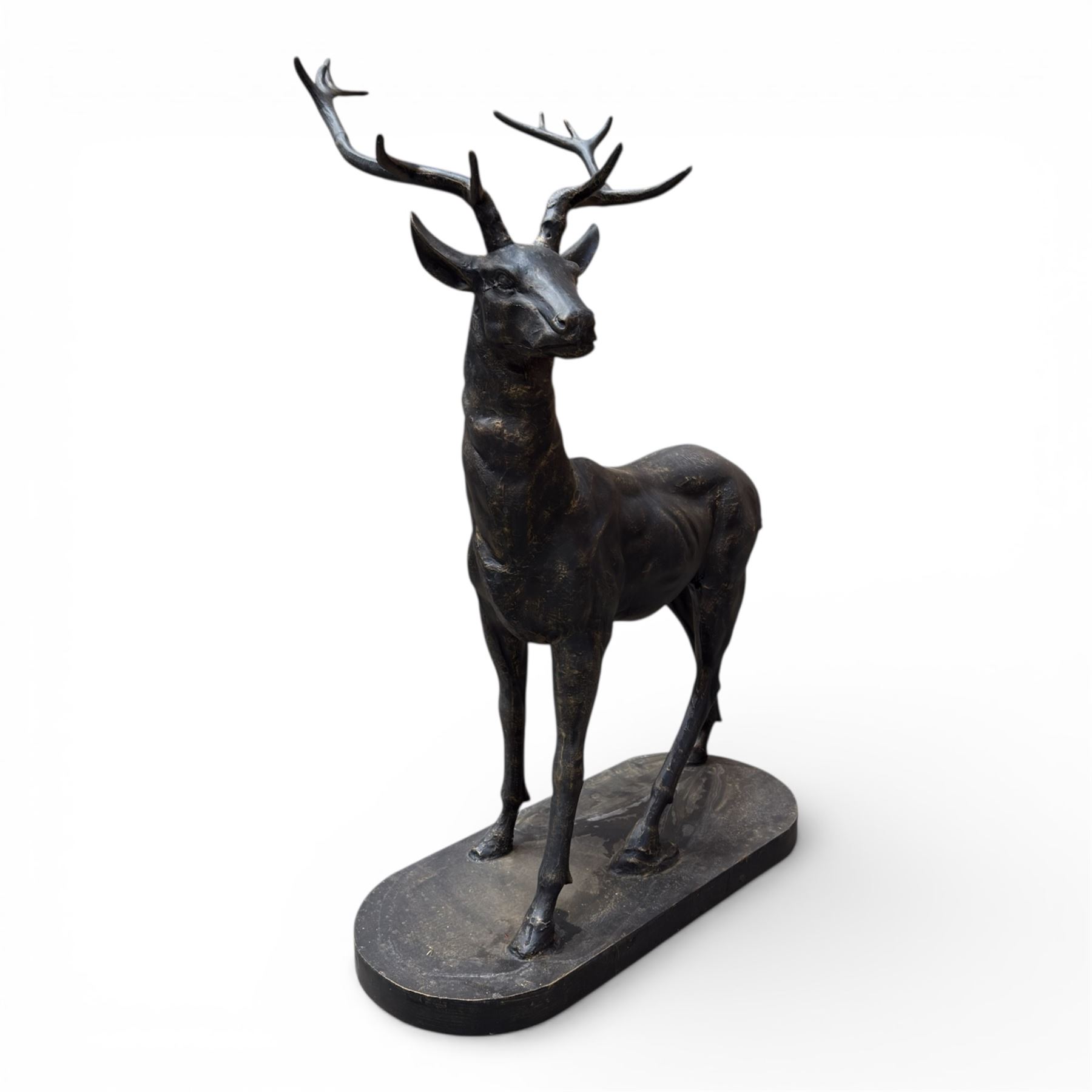 Pair of life-size cast iron garden or home stags, modelled standing upon oval plinths