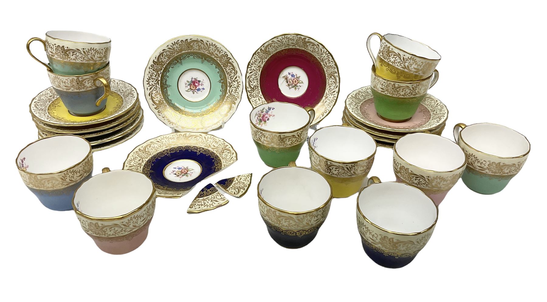 Twelve Spode Ruskin pattern coffee cups and saucers, with floral bouquets, varying colour grounds and gilt