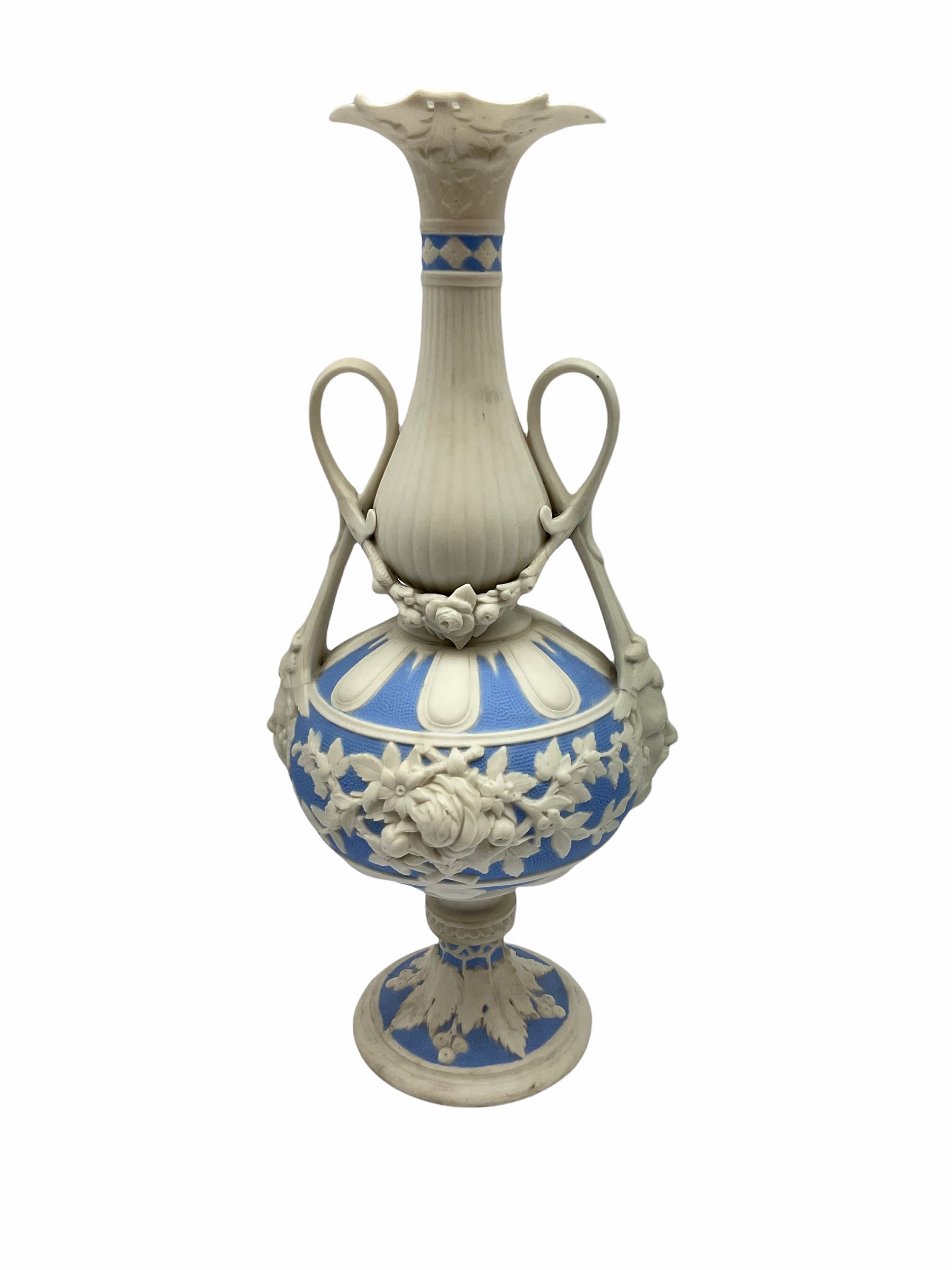Victorian Parian ware twin handled vase detailed with Bacus masks fruiting vines and floral sprays H36cm, together with a Parian jug H14.5cm, classical Parian sculpture H40cm, decorative plaque decorated in high relief depicting two children D18.5cm. 