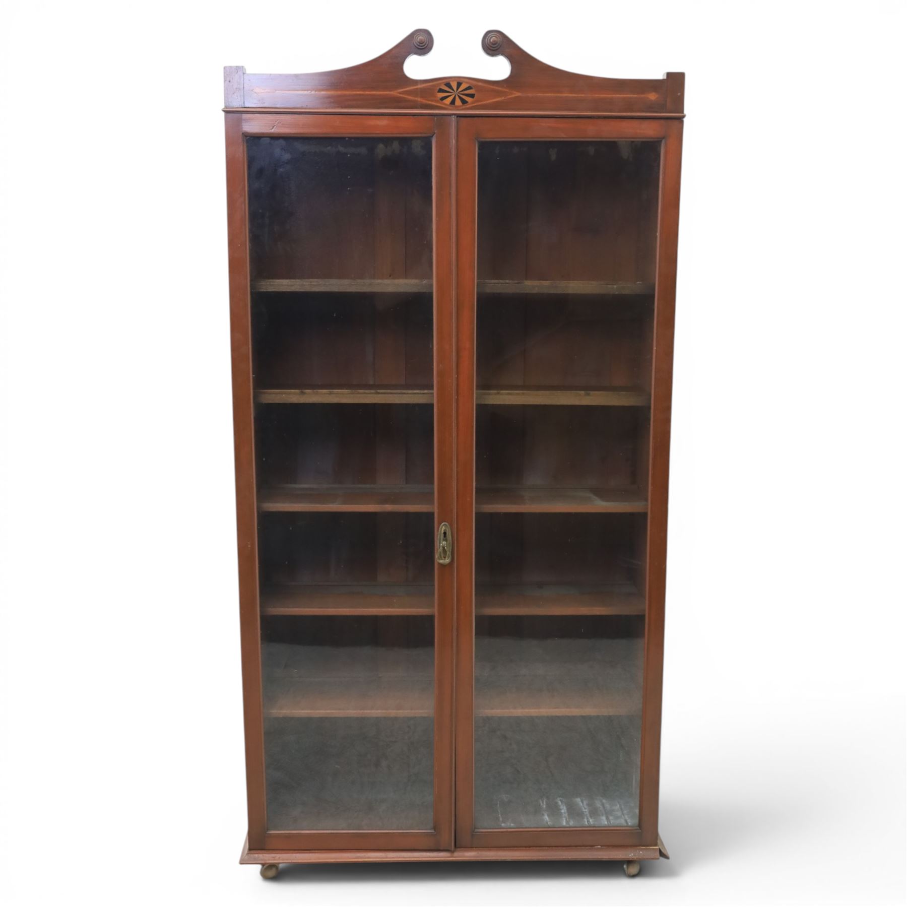 Edwardian walnut bookcase, fitted with two full height glazed doors, inlaid detail with checkered motif, adjustable shelves