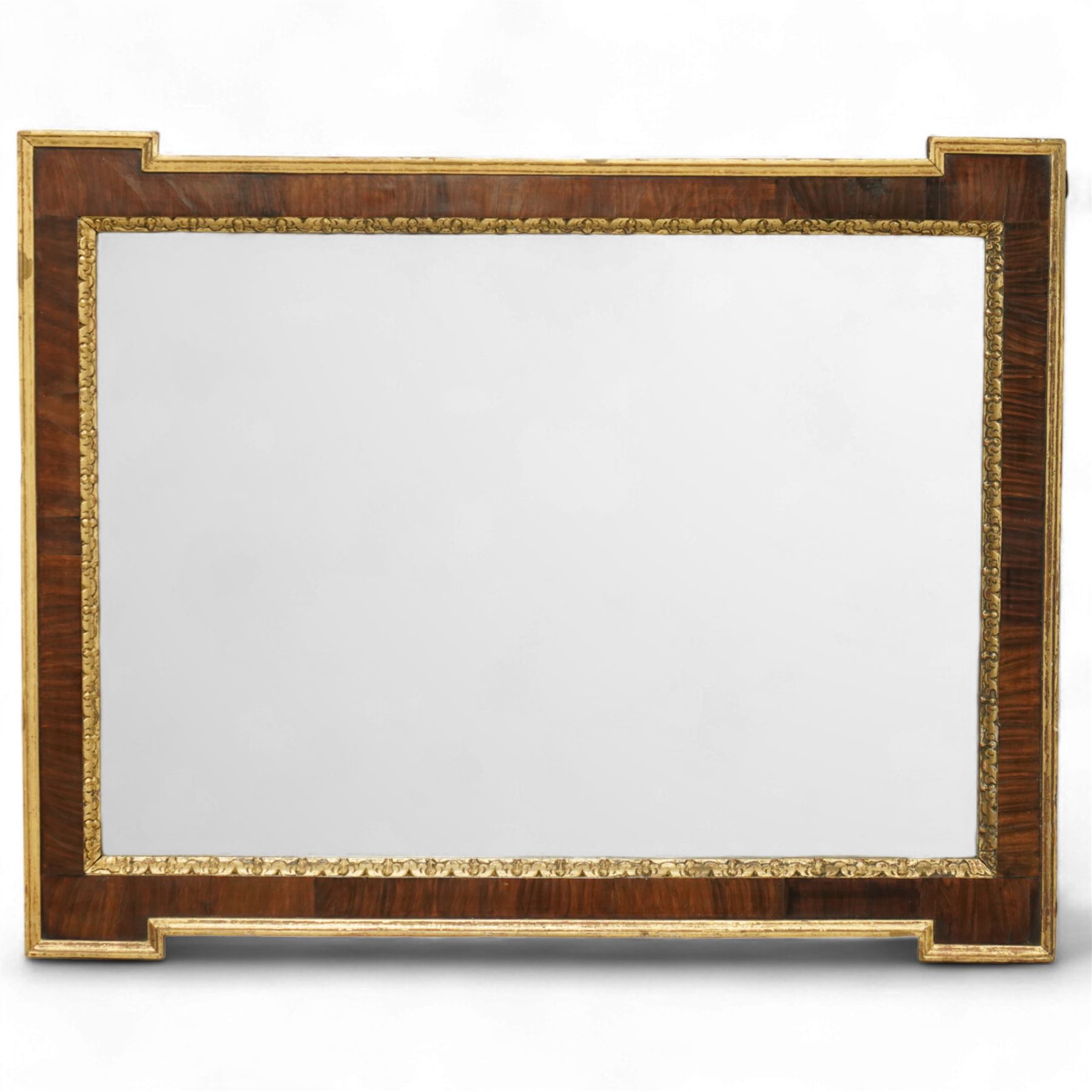 George I style mahogany and gesso architectural style wall mirror, with rectangular mirror plate bordered by gilt foliate moulded slip, within a shaped and crossbanded mahogany frame with stepped corner