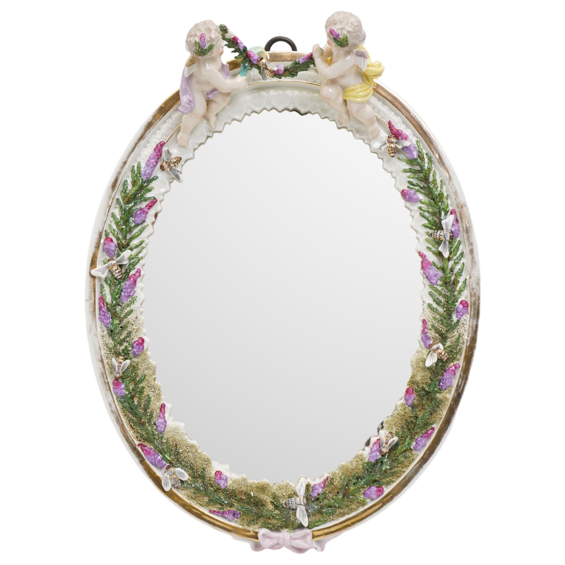 Sitzendorf oval table mirror with two cherubs holding a floral garland above foliage and insects etc on easel stand 40cm x 31cm