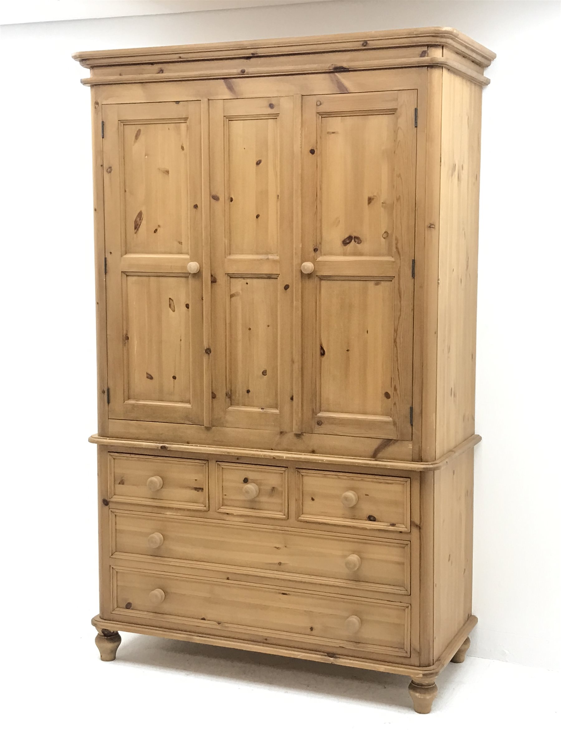 Waxed pine wardrobe enclosed by two panelled doors on chest fitted with