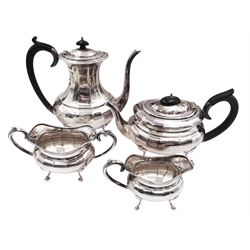 1920s silver four piece silver tea service, comprising coffee pot, teapot, milk jug and twin handled open sucrier, all a oval bellied form, with faceted body, and upon four pad feet, the coffee pot and teapot with ebonised handles and finials, hallmarked A & J Zimmerman Ltd, Birmingham 1925 & 1928