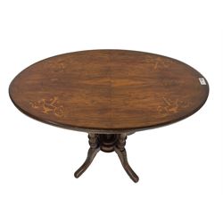 Victorian inlaid walnut centre table, the oval moulded top inlaid with urns and scrolls, on quadruple turned pillar base with circular platform and turned finial, four acanthus carved splayed supports