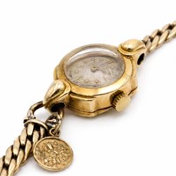 Omega ladies 18ct gold manual wind wristwatch, Cal. 212, silvered dial with dagger and dot hour markers, Birmingham 1953, on 9ct gold bracelet, with fold-over clasp, hallmarked