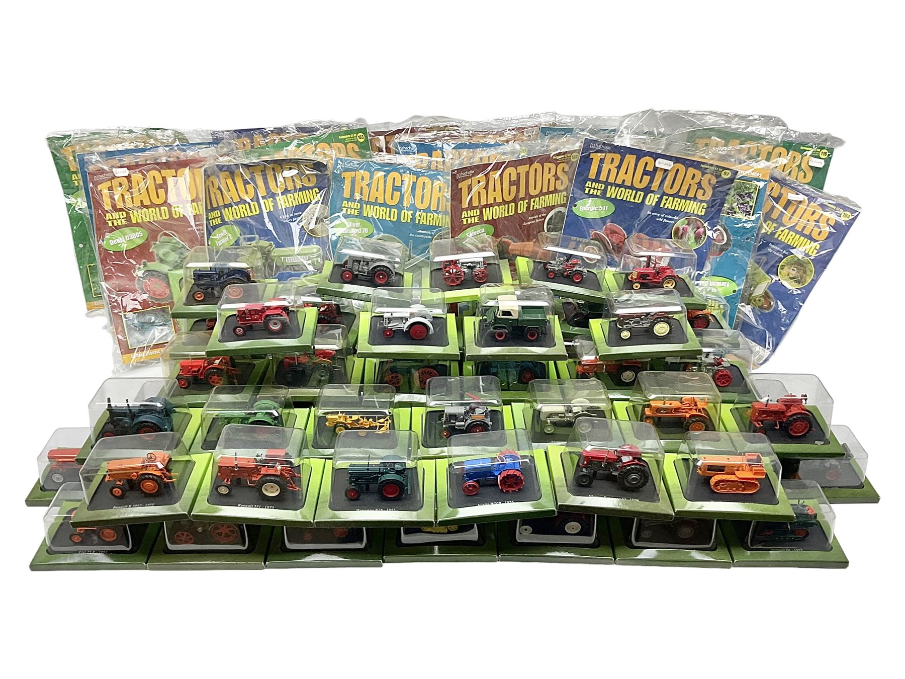 Eighteen issues of Tractors and The World of Farming magazine, together with sixty diecast tractors, all in original packaging, in three boxes 