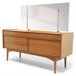 Golden Key By Palatial Ltd - mid-20th century teak dresser, three part mirror above a rectangular top, with six drawers with brass handles and pulls, upon splayed tapering legs 