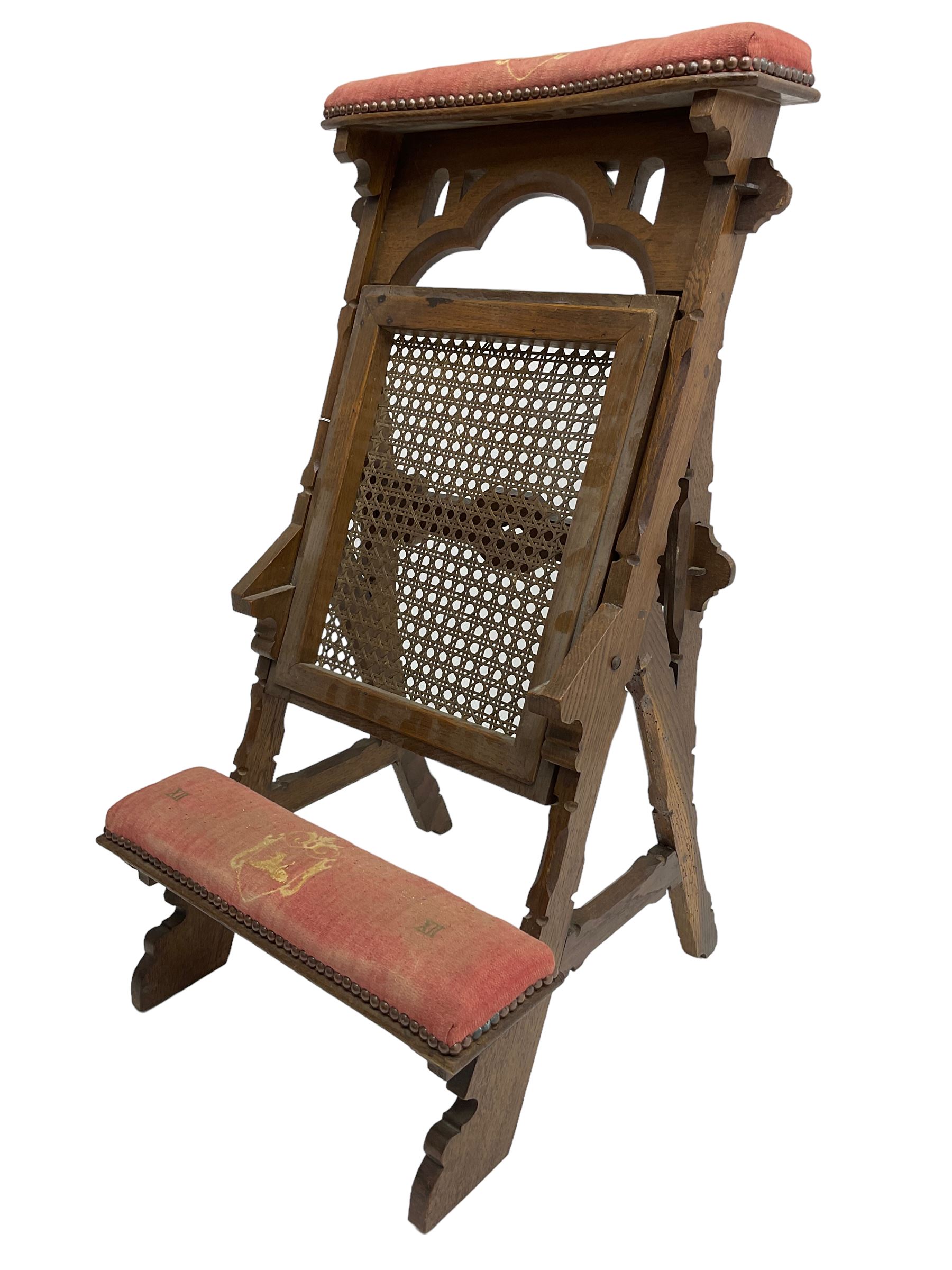 Late Victorian oak metamorphic prie-dieu chair, ecclesiastical design with pegged construction, upholstered kneel rest and top rest, hinged cane work seat