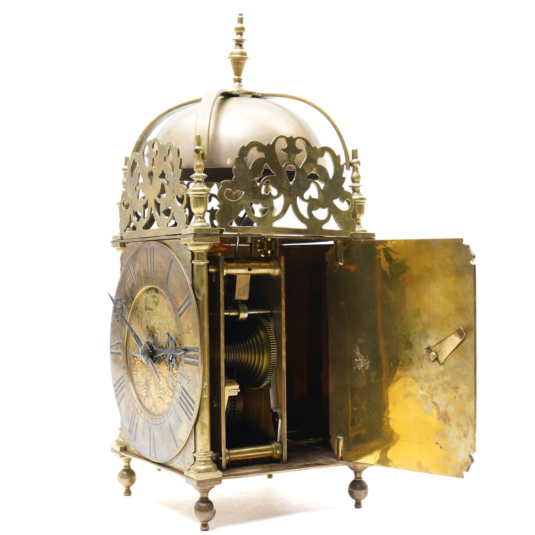 English-17th-century style replica 8-day lantern clock with a suspended bell and turned finials, with three ornate frets to the front and sides and opening side and rear doors, with an engraved dial centre and formerly silvered chapter with engraved Roman numerals, inner quarter hour track and period steel hands, dial engraved 