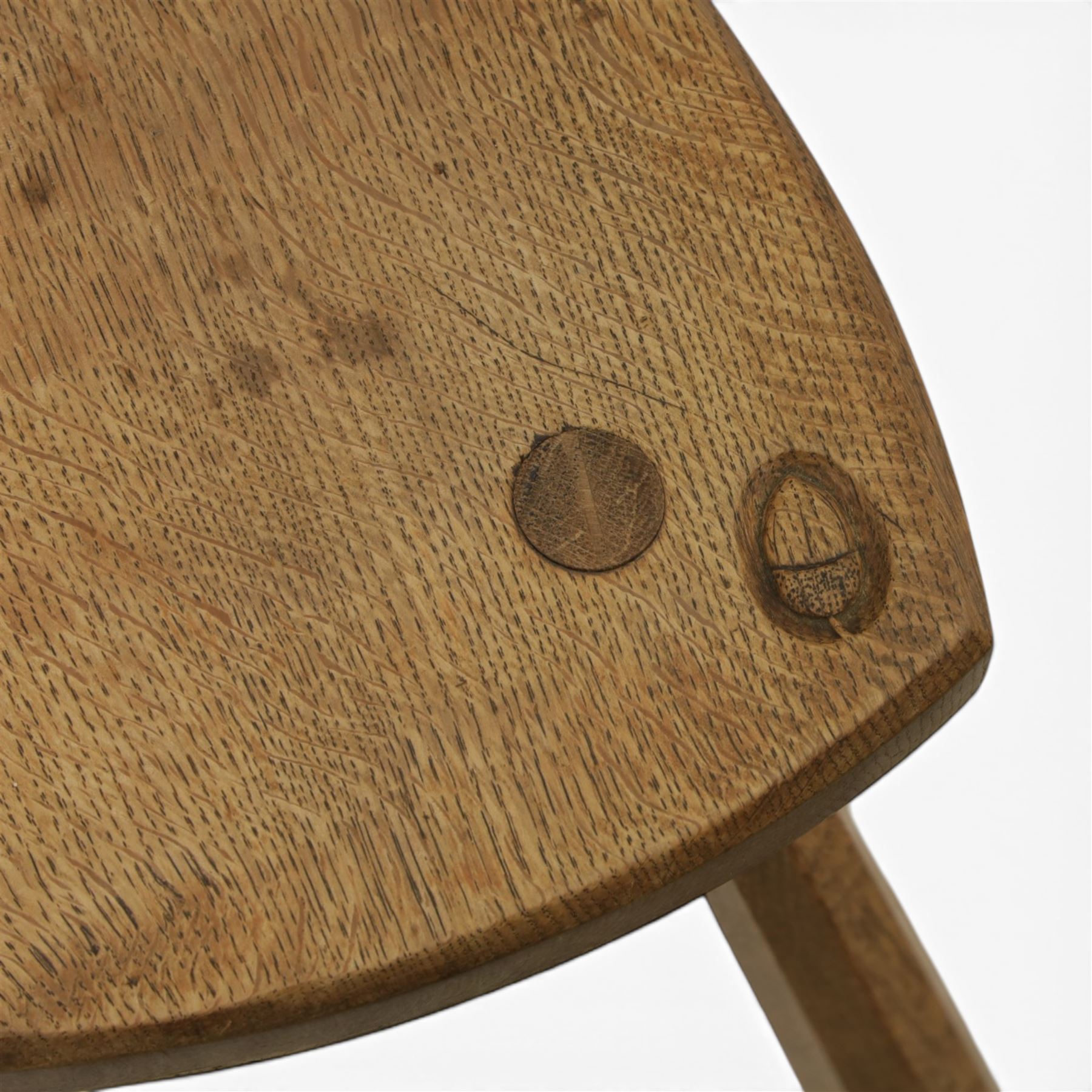 Acornman - oak milking stool, with signature acorn carving by the workshop of Alan Grainger of Brandsby