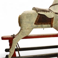 20th century carved and painted rocking horse, with original dappled paint finish, studded leather saddle and reins, on later red and black swing frame